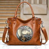 Fantasy Treats brown elephant handbag with ornate boho artwork, dual handles, and an adjustable crossbody strap.