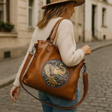 Fantasy Treats brown elephant handbag with boho gothic artwork, worn as a crossbody tote bag on a city street.