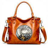 Fantasy Treats brown elephant handbag with ornate circular artwork, dual handles, and adjustable crossbody strap.